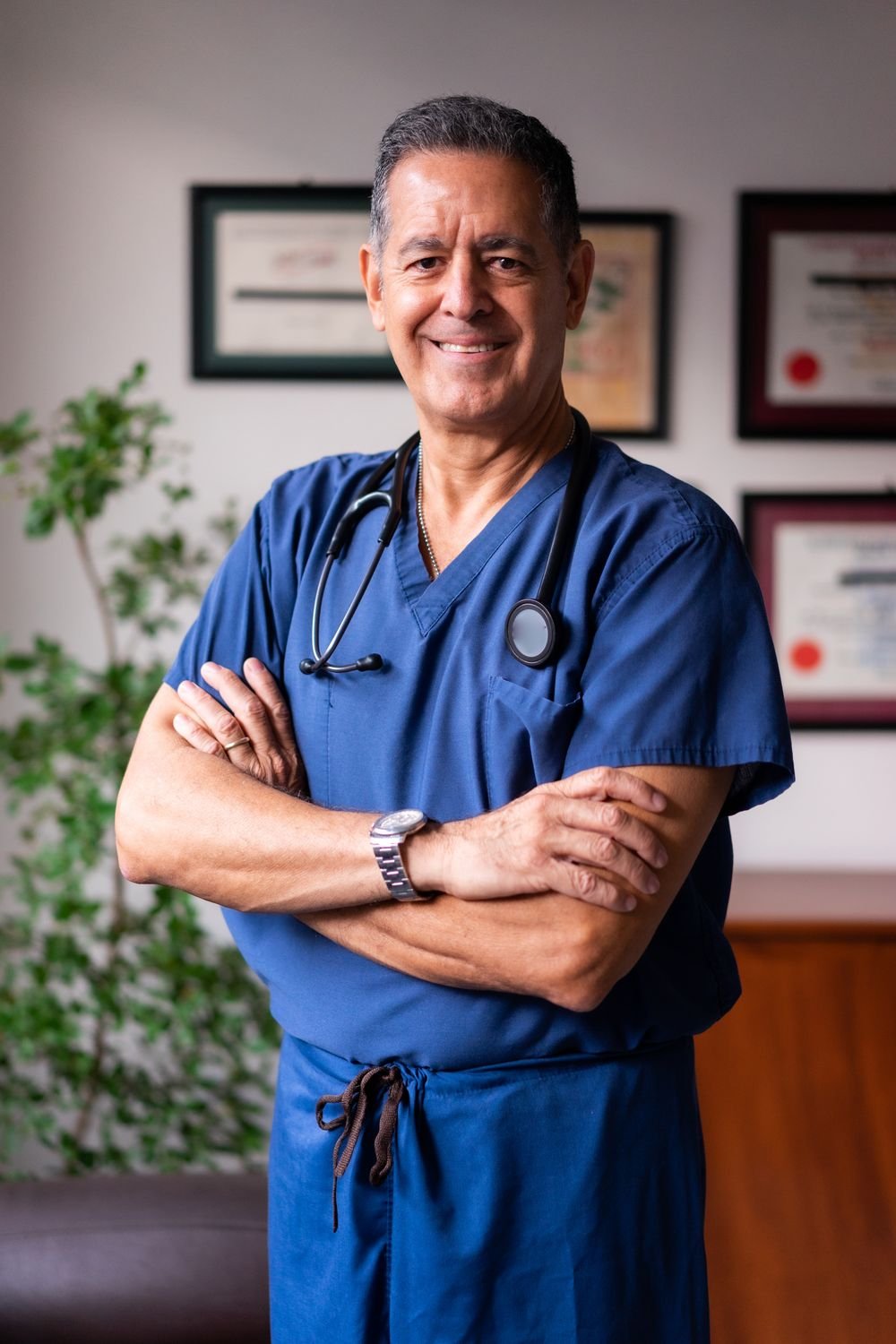A doctor in navy Aichano scrubs with a stethoscope
